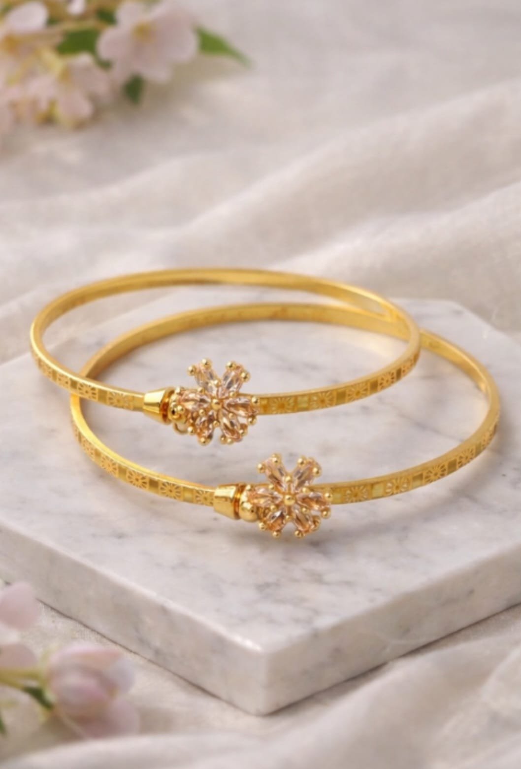 Elegant Two Gold Bangles with Floral Stone Design from Isabel Jewels - Image 2