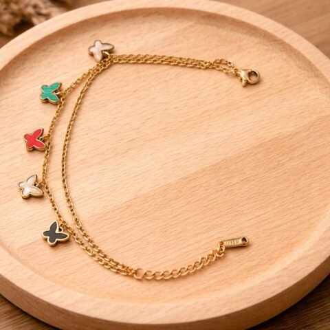 Gold butterfly charm bracelet designed Isabel Jewels